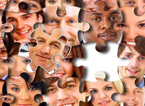 Jigsaw puzzle pieces with each piece showing a person's face