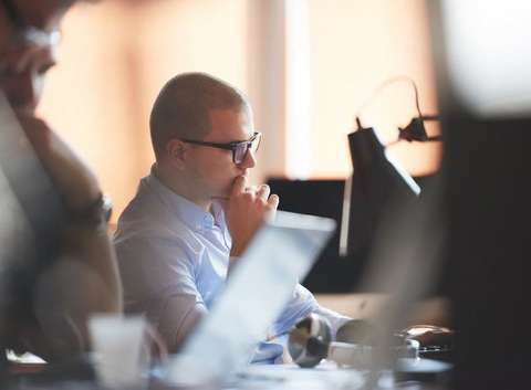 Blockchain cryptocurrency investor examining contents of computer screen